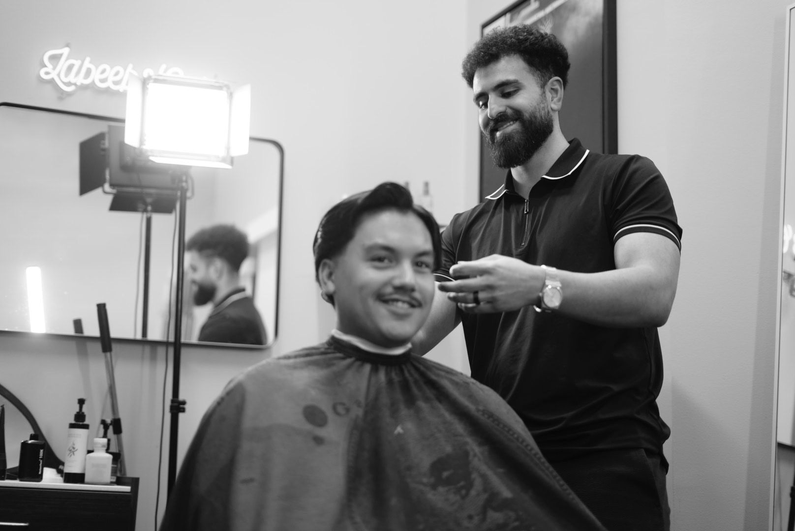 Labeeb cutting a client's hair in his private suite